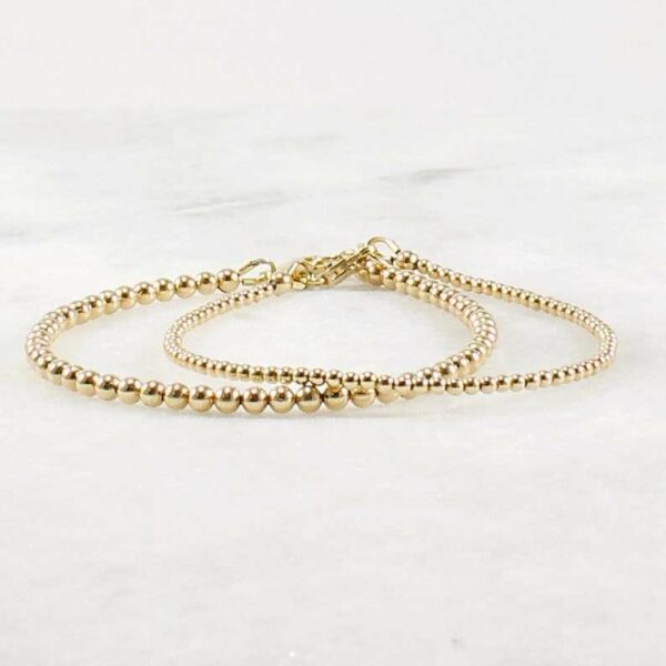 A delicate stacking wristlet, adorned with a 14K gold filled beaded bracelet, is a new fashion gift. - Image 2