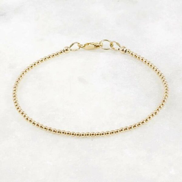 A delicate stacking wristlet, adorned with a 14K gold filled beaded bracelet, is a new fashion gift. - Image 3