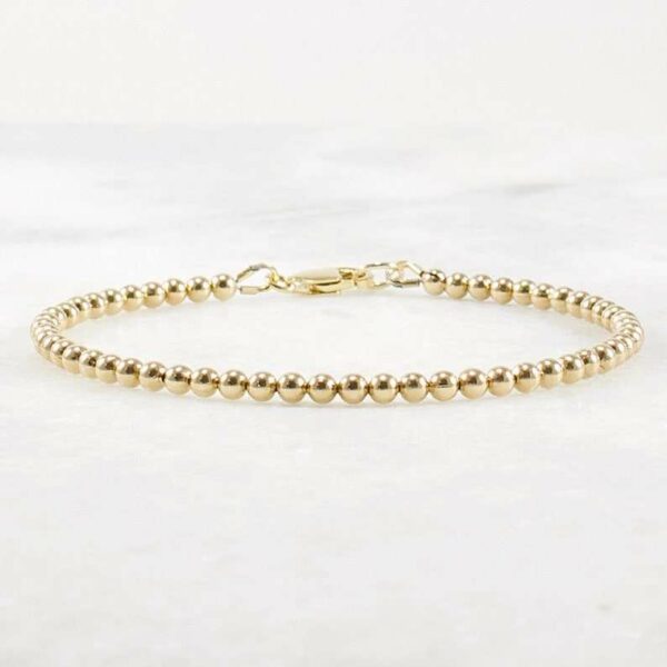 A delicate stacking wristlet, adorned with a 14K gold filled beaded bracelet, is a new fashion gift. - Image 4