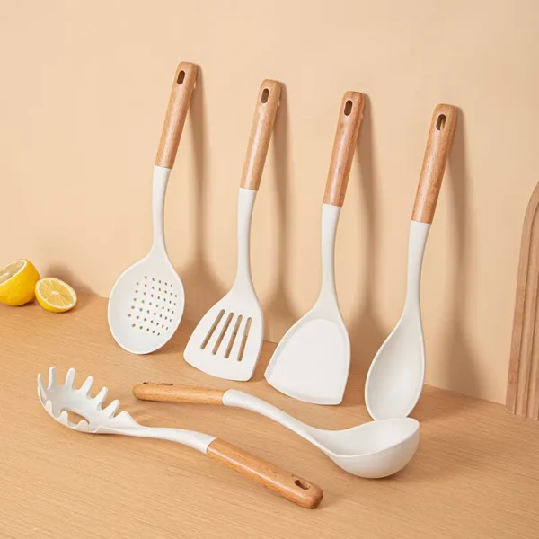 This 7-piece set of nonstick silicone kitchen utensils accessories with wood handles includes a spoon and spatula.