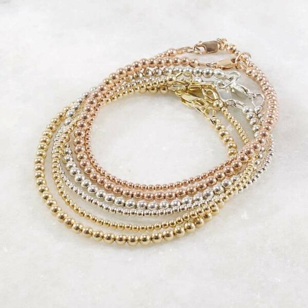 A delicate stacking wristlet, adorned with a 14K gold filled beaded bracelet, is a new fashion gift.