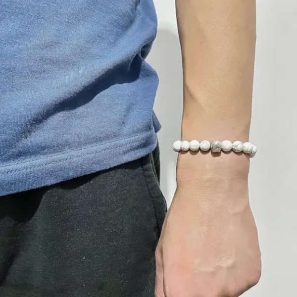 A straightforward birthday present for baseball fans, this men's white beaded sports bracelet with elastic silver band is made of stainless steel.