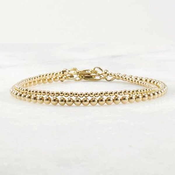 A delicate stacking wristlet, adorned with a 14K gold filled beaded bracelet, is a new fashion gift. - Image 7