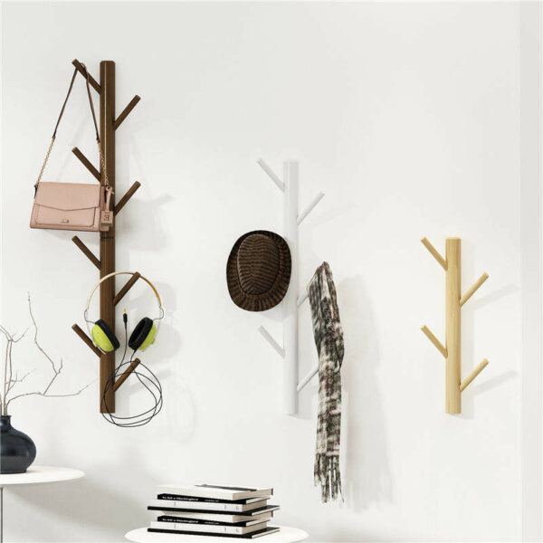 Wall-mounted wooden coat racks stands with a tree-shaped hanger for clothes and hats in the living room